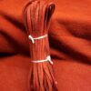 Red leather strips bundled with white ties.