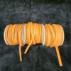 Orange ribbon spools on a black background.