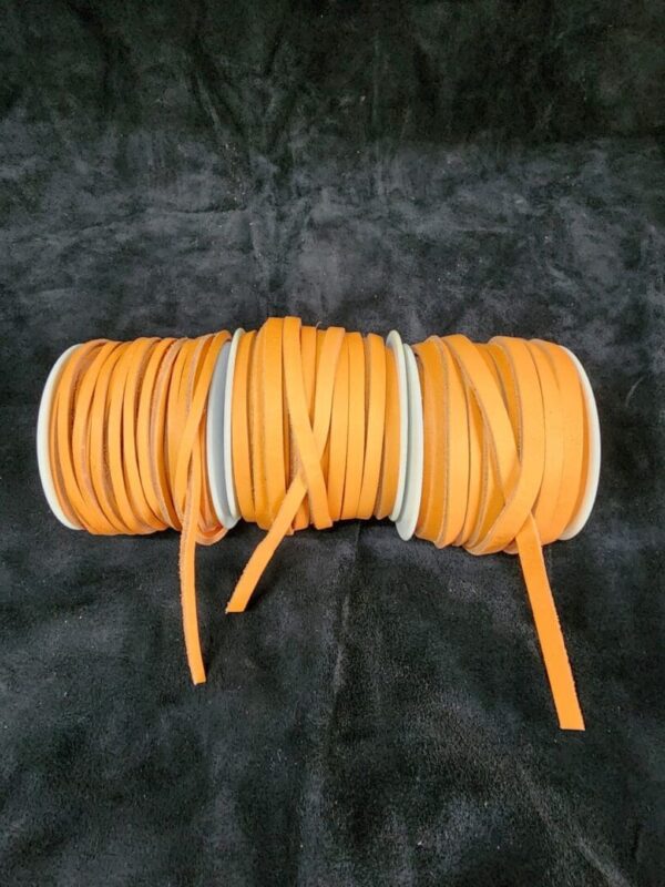 Orange ribbon spools on a black background.