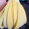 Hand holding yellow leather strips bundle.