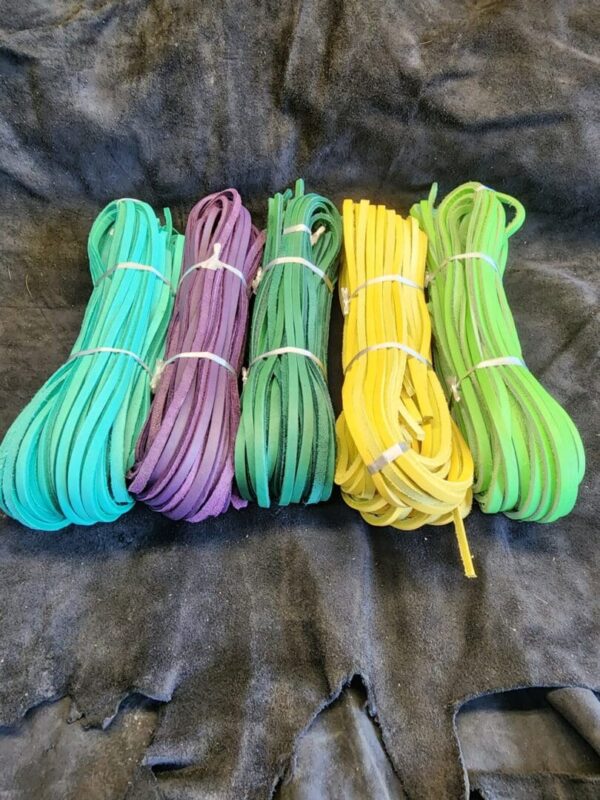 Colorful bundles of laces on dark fabric.