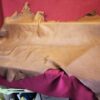 Brown leather hide on red fabric.