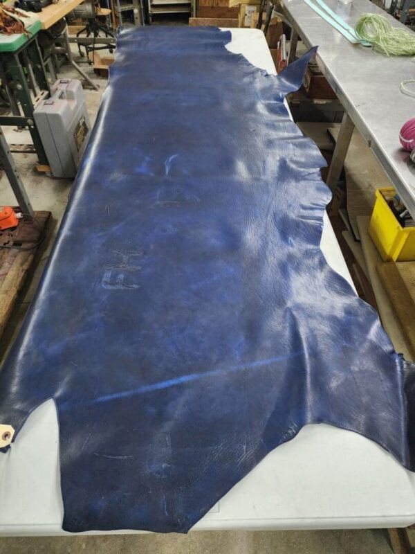 Blue leather hide on a workshop table.