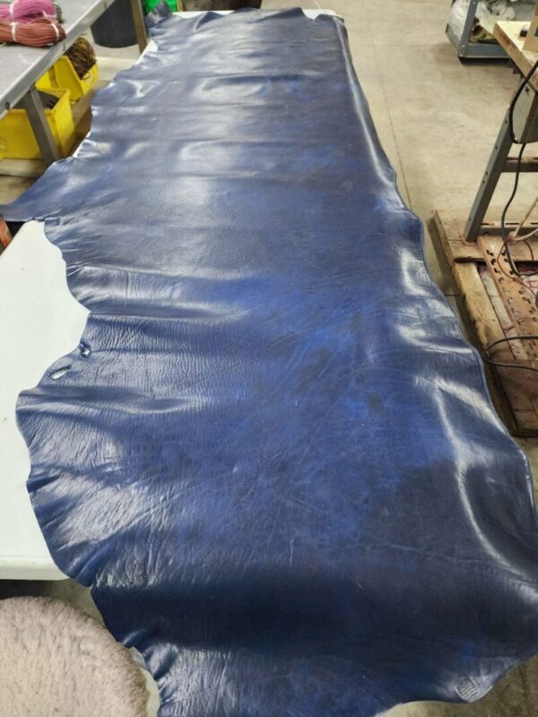 Blue leather hide on a workshop table.