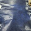 Blue leather hide on a flat surface.