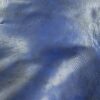 Blue leather texture with light reflections.