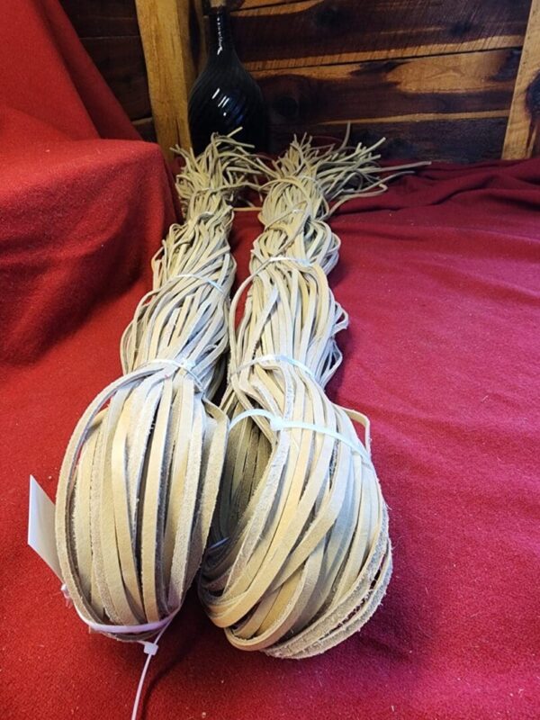 Two bundles of flat leather strips.