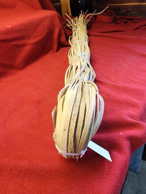 Braided leather strips on a red surface.