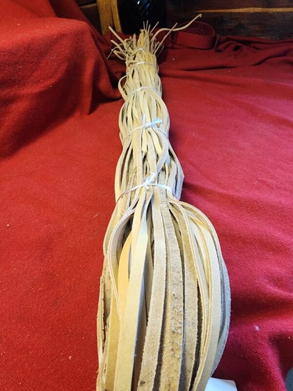 Leather strips bundled on red fabric.
