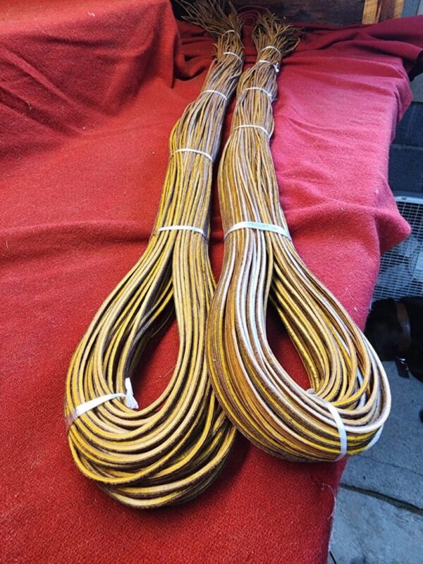 Two braided cords on a red surface.