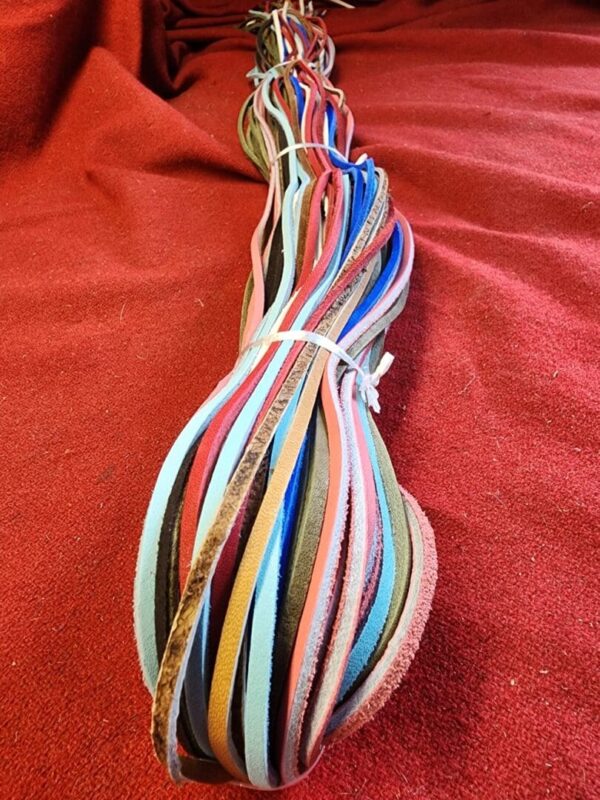 Colorful leather strips on a red background.