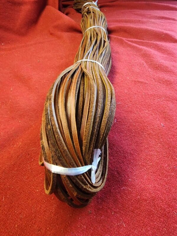 Coiled brown leather strips on red fabric.