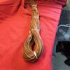 Brown coil of wire on red fabric.