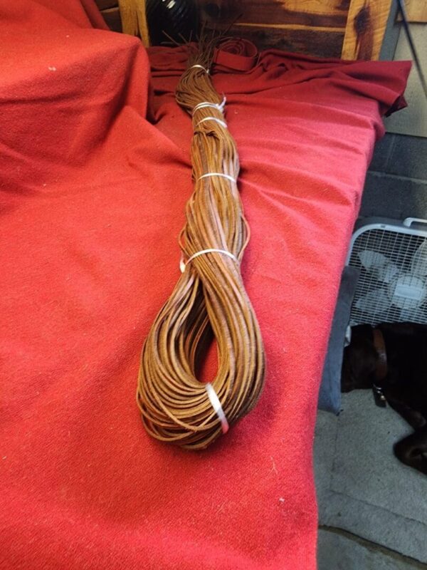 Brown coil of wire on red fabric.