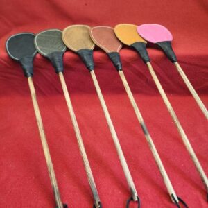 20240629_134356 Various paddles arranged on a red background.