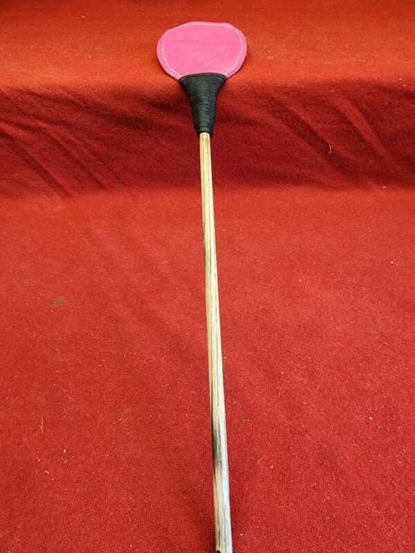 20240629_134502 Pink paddle on a wooden stick.