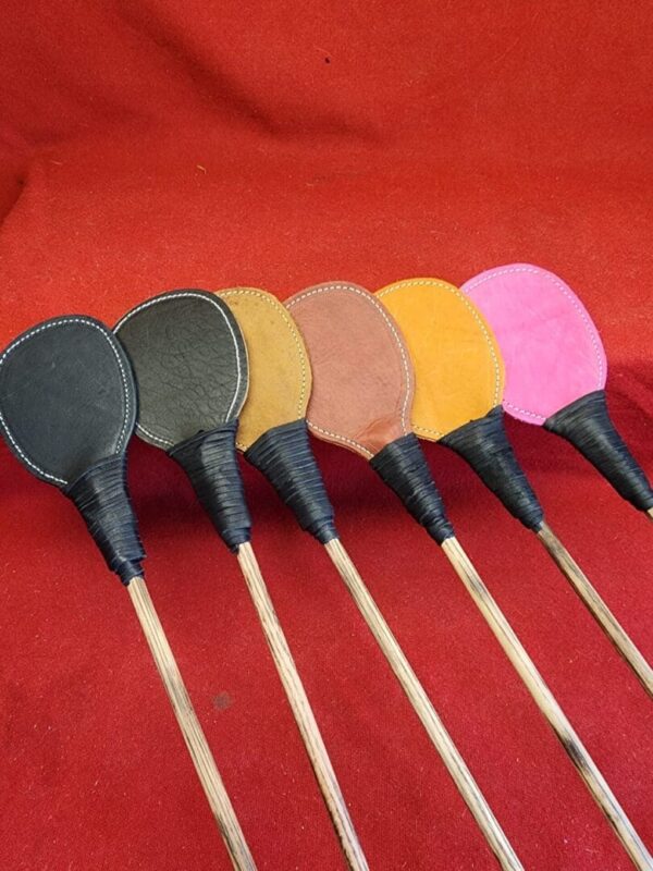 20240629_134525 Colorful handcrafted wooden utensils on red background.