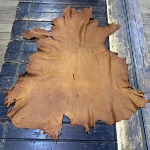 IMG_1855 Tanned leather hide on wooden surface.