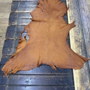 IMG_1860 Brown leather hide on wooden surface.