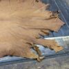 Leather hide spread on wooden table.
