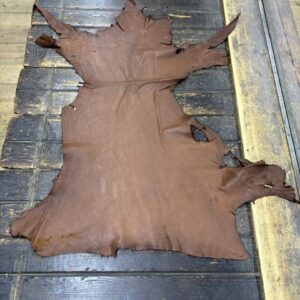 IMG_1884 Tanned leather hide on wooden table.