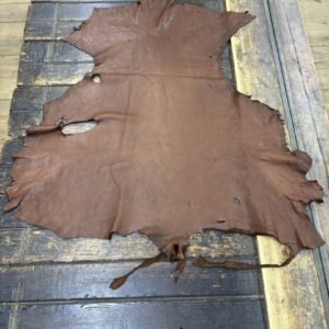 IMG_1888 Brown leather hide on wooden surface.