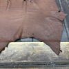 IMG_1890 Brown leather hide on wooden surface.