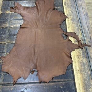 IMG_1892 Brown leather hide on wooden surface.
