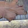 Brown leather hide on wooden surface.