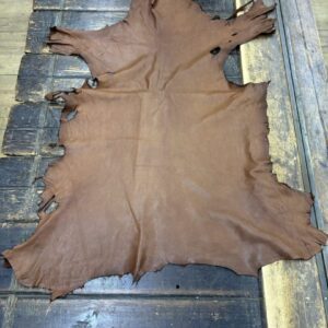 IMG_1896 Brown leather hide on wooden surface.