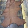 Brown leather hide on wooden surface.