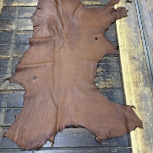 IMG_1900 Brown leather hide on wooden surface.