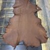IMG_1904 Brown leather hide on wooden surface.