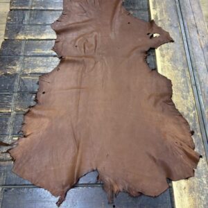 IMG_1904 Brown leather hide on wooden surface.