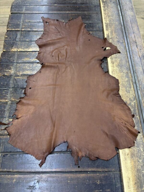 IMG_1904 Brown leather hide on wooden surface.