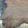 IMG_1905 Brown leather hide on wooden surface.