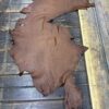 IMG_1908 Brown leather hide on wooden surface.