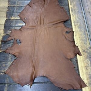 IMG_1912 Brown leather hide on wooden surface.