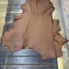 Brown leather hide on wooden surface.