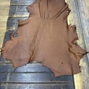 IMG_1917 Brown leather hide on wooden surface.