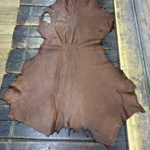 IMG_1921 Brown leather hide on wooden surface.