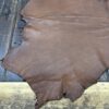 IMG_1922 Brown leather hide on wooden surface.