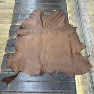 IMG_1925 Brown leather hide on wooden table.