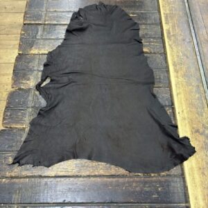 IMG_1945 Black leather hide on wooden surface.