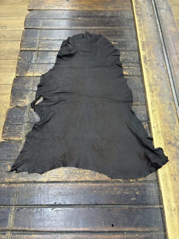 Black leather hide on wooden surface.
