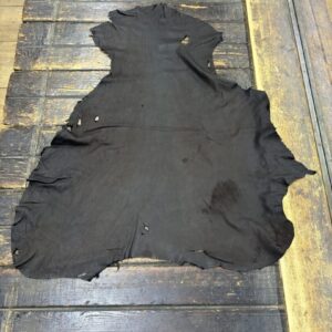 IMG_1949 Black leather hide on wooden surface.