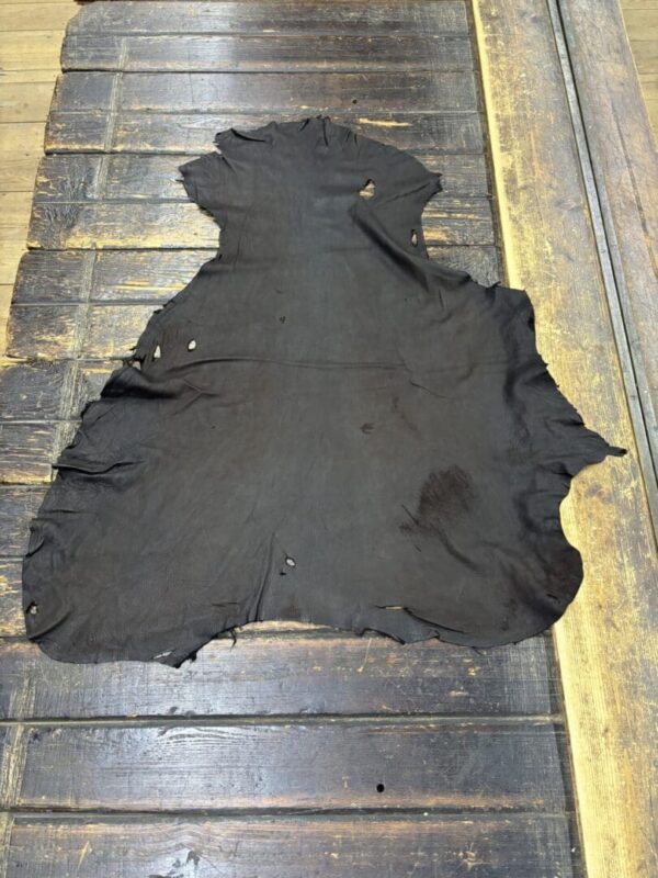 Black leather hide on wooden surface.
