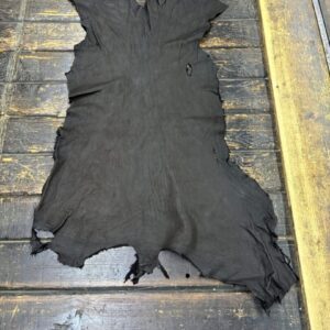 IMG_1957 Black leather hide on wooden surface.