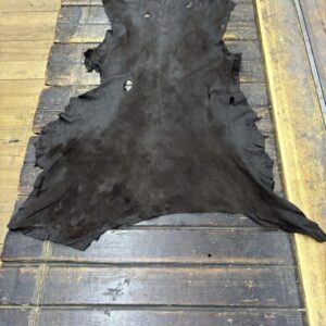 IMG_1961 Black animal hide on wooden surface.