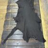 Black animal hide on wooden floor.